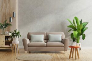 Brown sofa and a wooden table in living room interior with plant,concrete wall.3d rendering